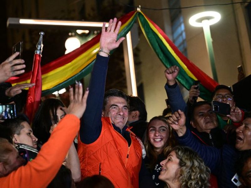 Rodrigo Paz, Bolivia's presidential candidate for the Christian Democratic Party (PDC), greets his supporters next to his wife Maria Elena Urquidi following the results of the presidential election in La Paz, Bolivia on August 17, 2025. Jorge "Tuto" Quiroga, a right-wing former president, and Rodrigo Paz, a senator from Bolivia's richest regions, will go head-to-head in the country's presidential runoff in October after leading the first round of voting on August 17, 2025. (Photo by Martin BERNETTI / AFP)