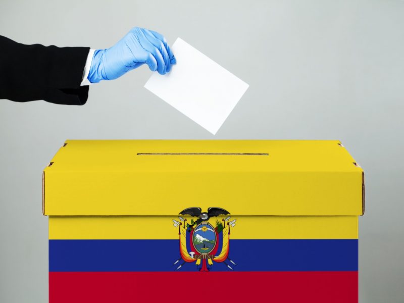 Person,Wearing,Suit,Casting,Vote,In,Ballot,Slot,hand,In,Blue